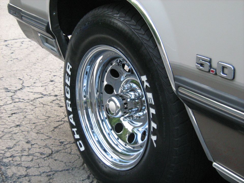 Chrome wheel with white lettered 'Charger' tire and '5.0' badge on side