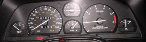 Dashboard gauges with speedometer, tachometer, fuel, oil, and temperature