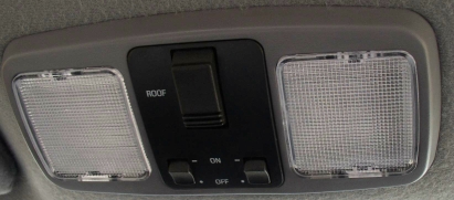 1994 Ford Thunderbird - Interior overhead console with lights and switches, including text labels for 'ROOF', 'ON', and 'OFF'.