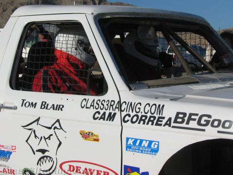 1990 Ford Bronco - Close-up of a white off-road race truck's caged door lettered Tom Blair, Class3Racing.com and Cam Correa with sponsor logos.