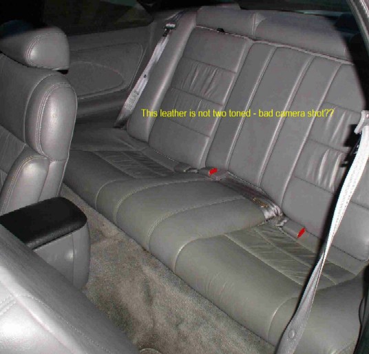 Gray leather rear bench seat in a two-door coupe with annotation text overlay