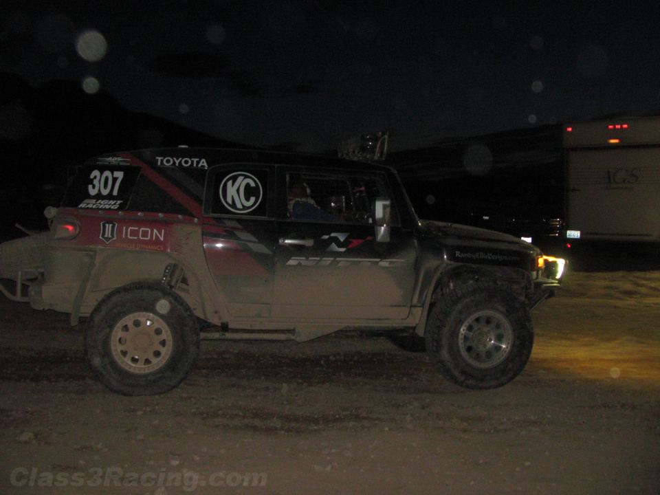 Dark off-road race truck number 307 with Toyota and ICON decals at night