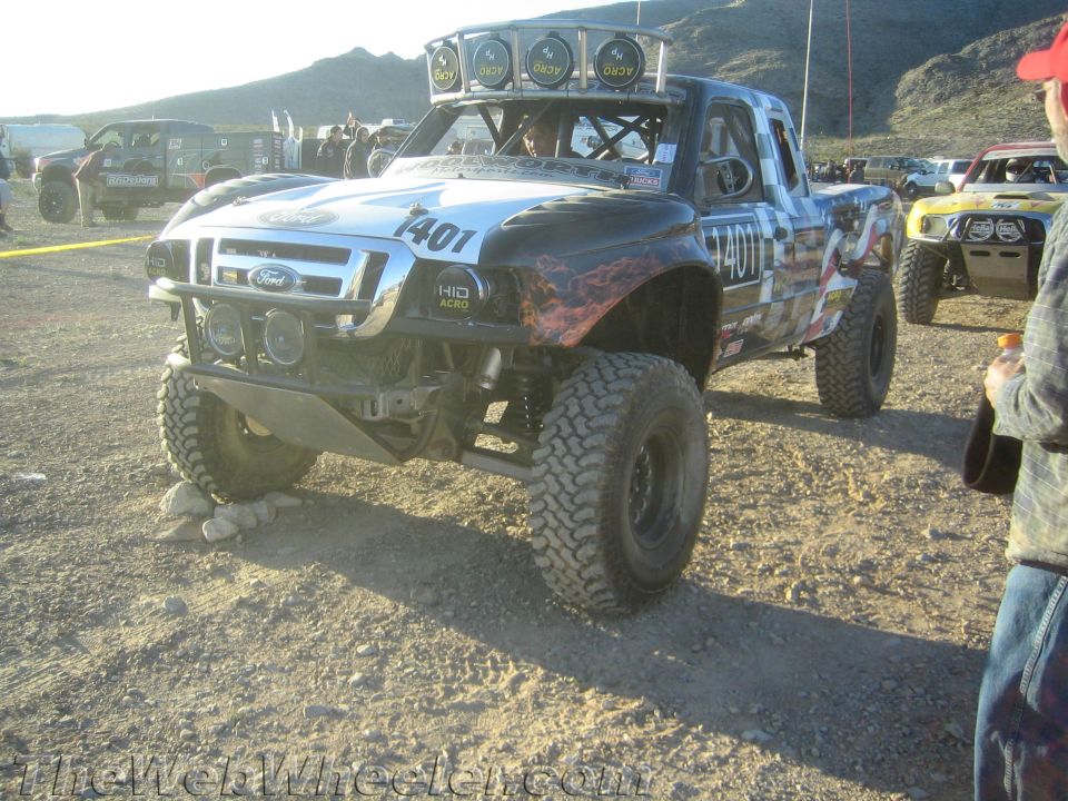 Ford off-road race truck number 1401 with flame graphics and roof lights