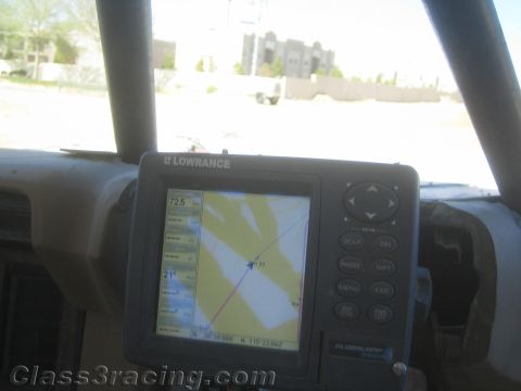 1990 Ford Bronco - Lowrance GPS navigation unit mounted on a dash displays a route map, with buildings visible through the windshield.