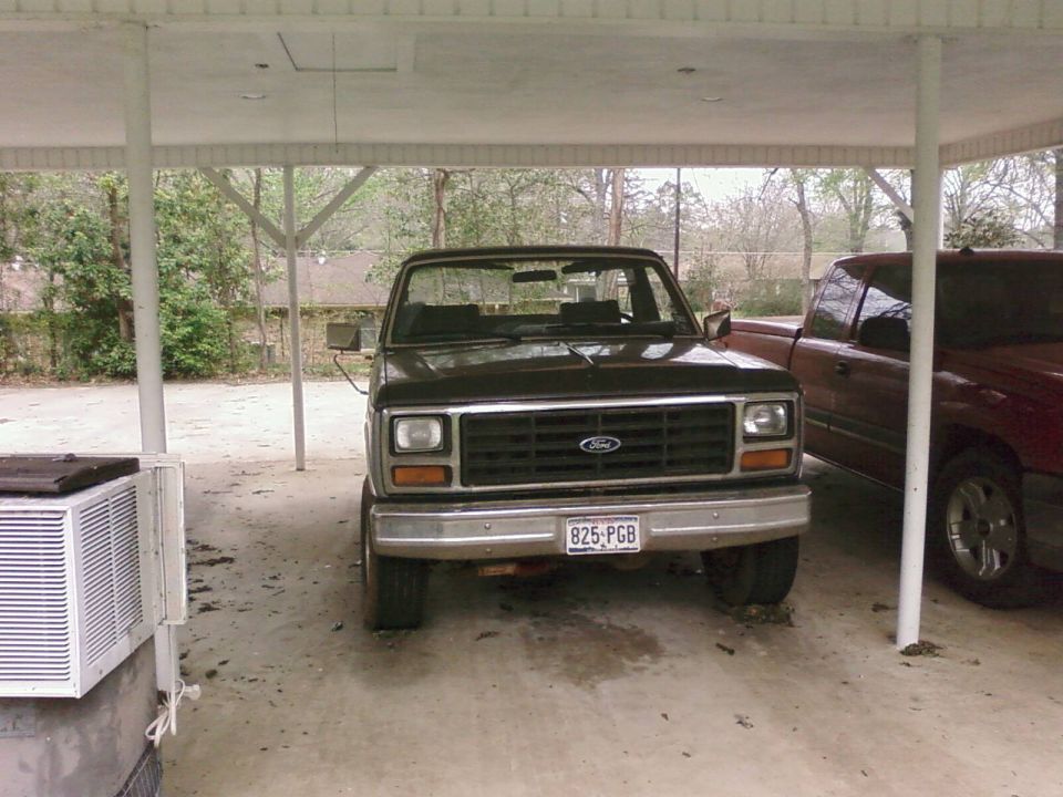 Black Ford truck front view with license plate 825-PGB