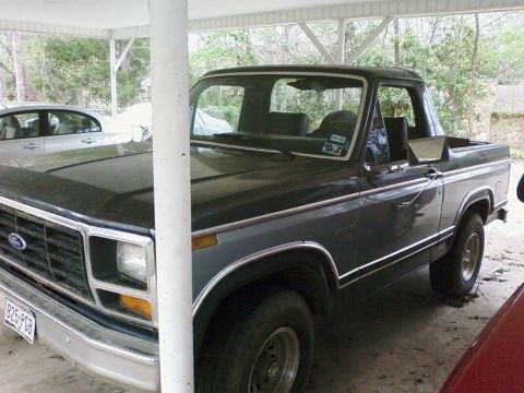 1983 Ford Bronco - This 1983 Ford Bronco is parked under a carport, partially obscured by a support column.