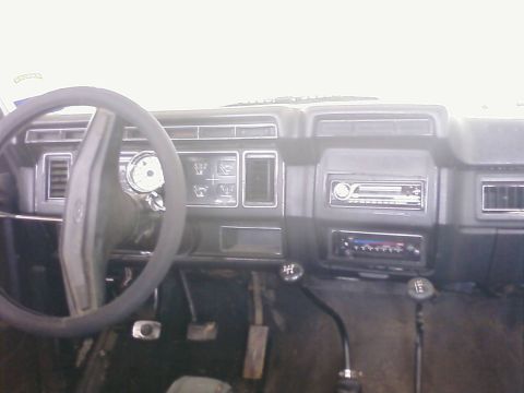 1983 Ford Bronco - Interior shot of a vehicle's dashboard with two gear shifters visible.