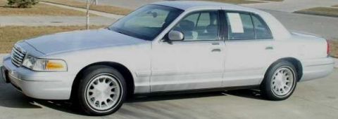 1999 Ford Crown Victoria - This 1998 Ford Crown Victoria sedan is viewed from the side, showing its classic full-size car profile.