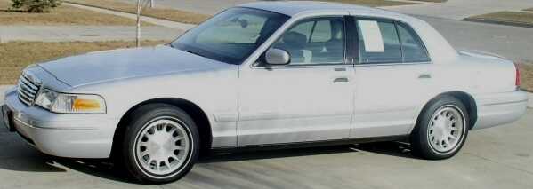 Silver 1998 Ford Crown Victoria sedan, side view