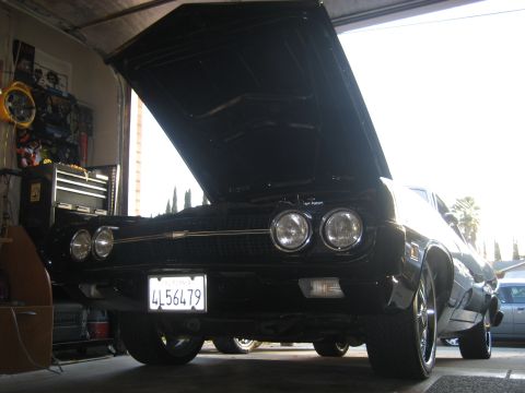 1970 Ford Ranchero - Front view of a black 1970 Ford Ranchero parked in a garage with the hood open.