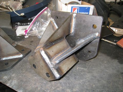 1996 Ford Bronco - Welded metal brackets are shown on a workbench, possibly for automotive modification.