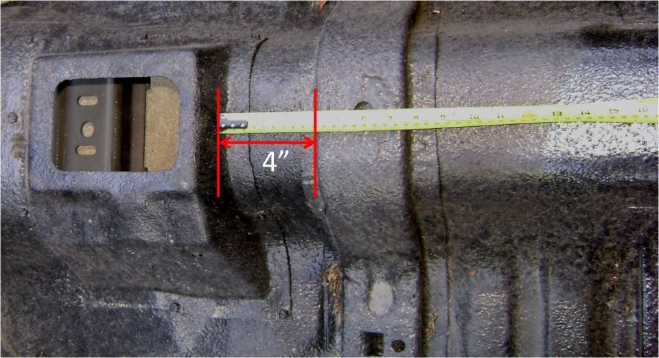 Undercarriage transmission tube with tape measure showing 4-inch span