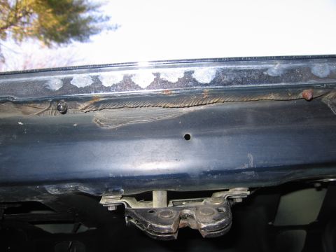 1991 Ford LTD Crown Victoria - The trunk latch mechanism is visible, with some rust and wear on the surrounding metal.