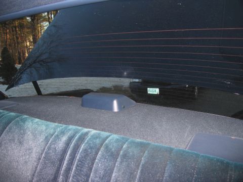 1991 Ford LTD Crown Victoria - View from the rear seat looking out the window, showing another vehicle in the background.