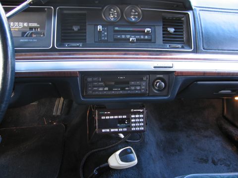 1991 Ford LTD Crown Victoria - The interior of a 1991 Ford Crown Victoria LTD, a radio, dual gauges, and a mounted Motorola communication device.