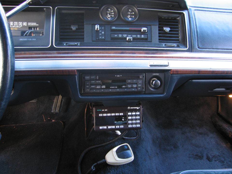 Interior dashboard of a 1991 Ford Crown Victoria LTD, showing the radio, gauges, and a Motorola communication device