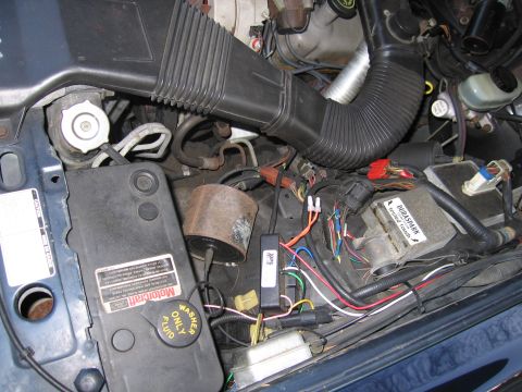 1991 Ford LTD Crown Victoria - Close-up of a vehicle's engine bay, showing various components and wiring.