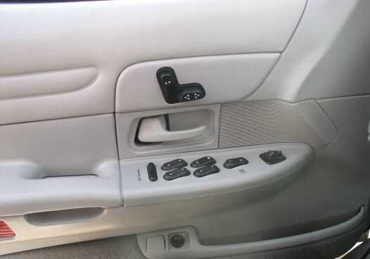 Driver's side door panel with window and lock controls. This is a 1999 Ford Crown Victoria