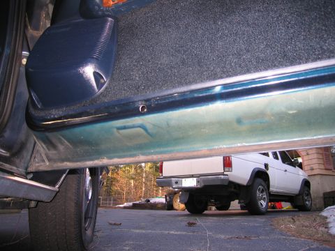 1991 Ford LTD Crown Victoria - The interior door sill is visible in the foreground, with a white pickup truck parked outside.