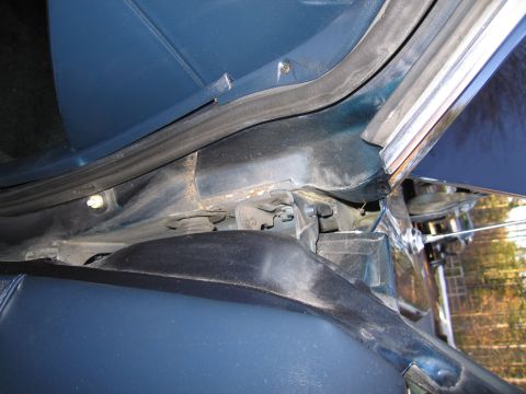 1991 Ford LTD Crown Victoria - Detail shot of the door jamb area on a blue vehicle, showing interior trim and seals.