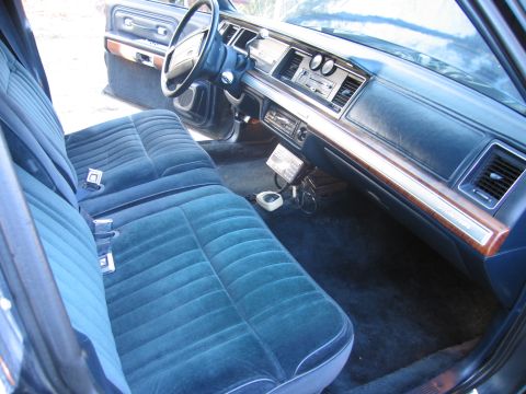 1991 Ford LTD Crown Victoria - Interior view of a 1991 Ford Crown Victoria LTD, highlighting the blue velour seats and dashboard details.
