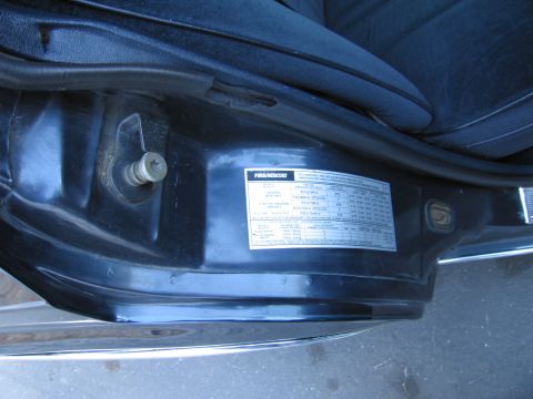 1991 Ford LTD Crown Victoria - Small vehicle spec/tire-pressure placard label affixed to a body panel, photographed in the door area.