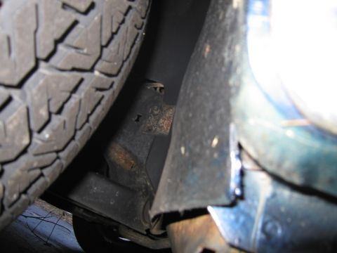 1991 Ford LTD Crown Victoria - Detail shot of a car's undercarriage, showing suspension and tire.