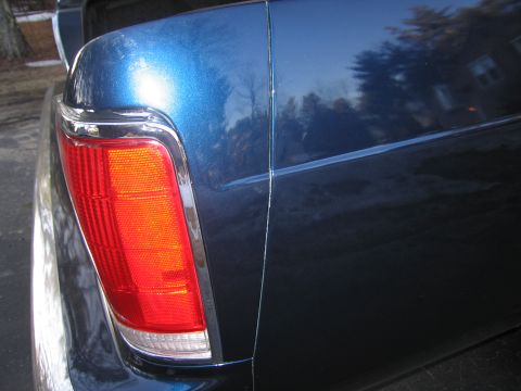 1991 Ford LTD Crown Victoria - Rear view of a blue vehicle, focusing on the tail light and body panel details.