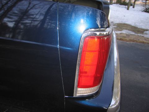 1991 Ford LTD Crown Victoria - Detail shot of a car's rear corner, showing the tail light assembly and metallic blue paint.