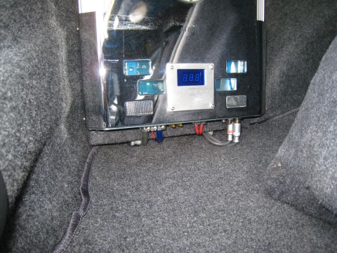 2007 Subaru Impreza - Car audio amplifier with digital display and RCA connections installed in a vehicle's trunk.