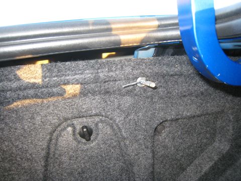 2007 Subaru Impreza - Close-up of a car's trunk interior, showing carpet and a metal pin.