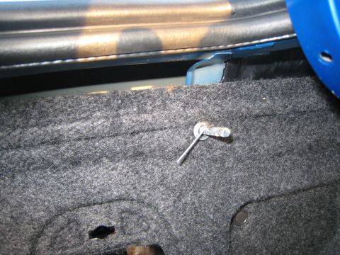 2007 Subaru Impreza - Close-up view of a trunk latch pin mechanism, showing the metal pin and surrounding carpeted interior.