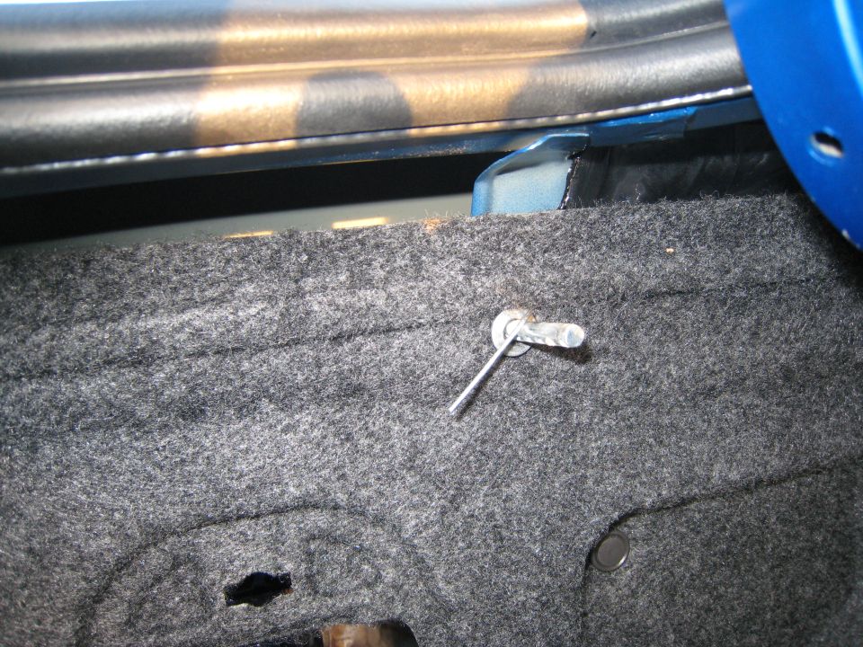 Trunk latch pin mechanism inside a blue vehicle