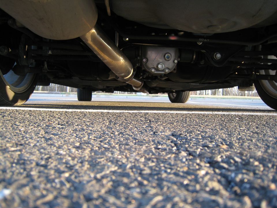 Underside view of a car's exhaust pipe and rear differential