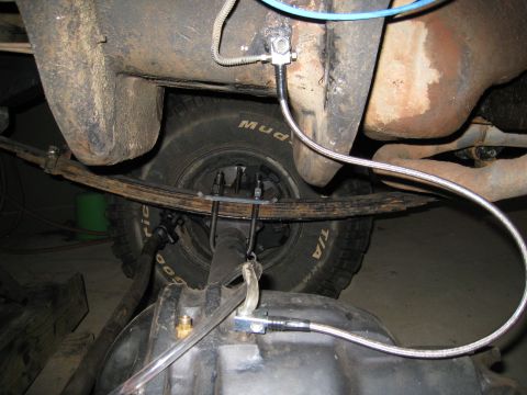 1996 Ford Bronco - Close-up view of a vehicle's undercarriage, focusing on suspension and drivetrain components.