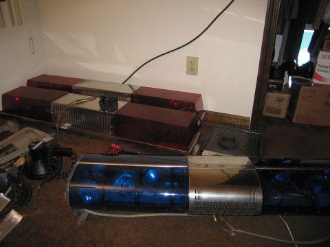 1991 Ford LTD Crown Victoria - Emergency light bars with blue and red lenses are displayed indoors.