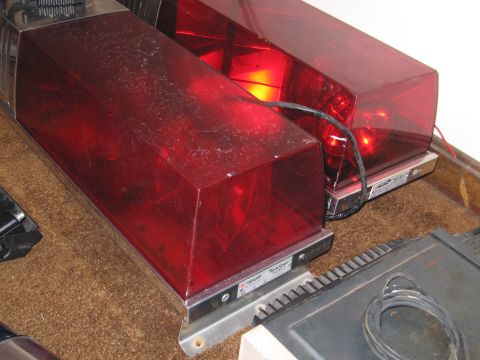 1991 Ford LTD Crown Victoria - Close-up of a red emergency light bar, likely for a police or emergency vehicle, showing its construction and wiring details.