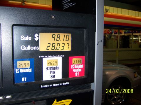 1991 Ford Bronco - A silver car is seen at a gas station with the pump display showing the sale amount and gallons dispensed.