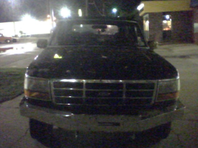 Front view of a dark-colored Ford Bronco, likely from the early to mid-1990s