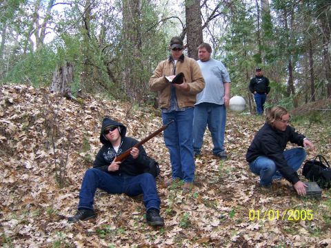 1991 Ford Bronco - A group of men are gathered in a wooded area, with one individual holding a rifle. The photo is dated January 1, 2005.