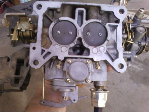 1978 Ford Bronco - Close-up view of a carburetor, showing its internal components and throttle plates.