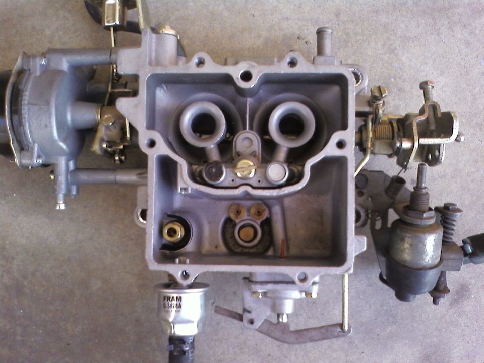 Holley carburetor with dual barrels and a FRAM filter attached