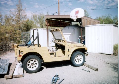 1988 Suzuki Samurai - This 1988 Suzuki Samurai is seen in a yard with a basketball hoop in the background.