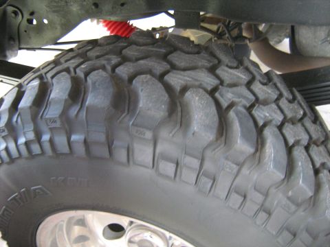 1993 Ford Bronco - This image shows a close-up of an off-road tire and suspension parts, not a complete vehicle.