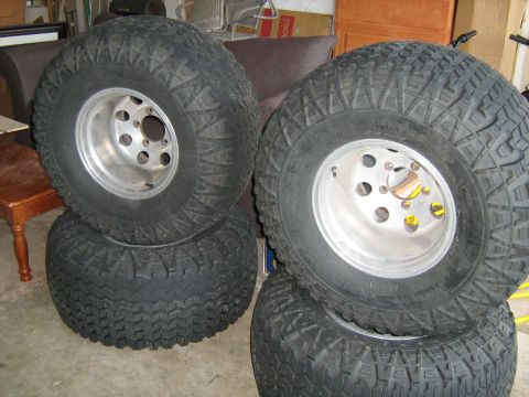 1993 Ford Bronco - Set of four off-road tires and rims, likely for an SUV or truck.