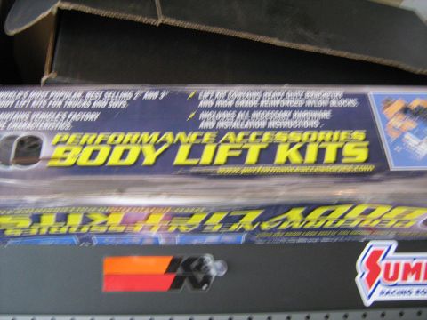1993 Ford Bronco - Boxes of performance body lift kits are stacked, with branding visible from Performance Accessories and Summit Racing.