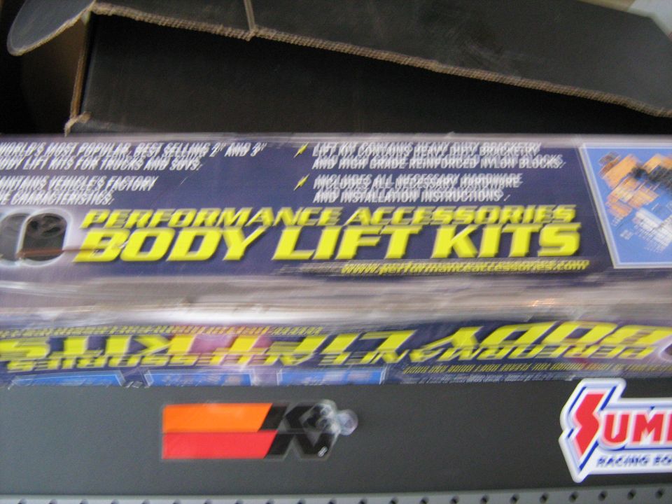 Boxes for performance body lift kits, one says 'Performance Accessories Body Lift Kits'