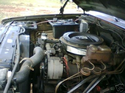1987 Suzuki Samurai - View of the engine bay, showing the alternator, battery, and air cleaner assembly.