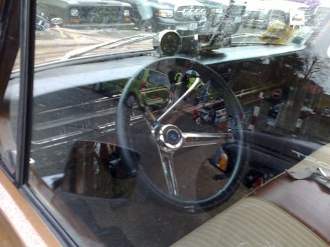 1991 Ford Crown Victoria - The interior of a car is visible, with reflections of other vehicles in the windshield.