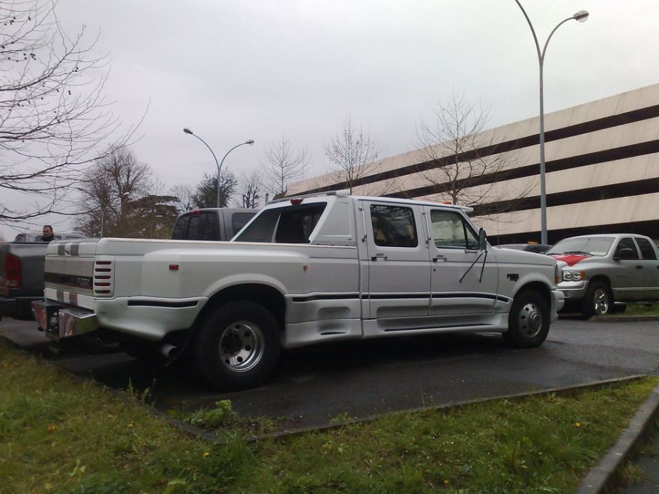 Silver Ford crew-cab dually pickup parked outdoors